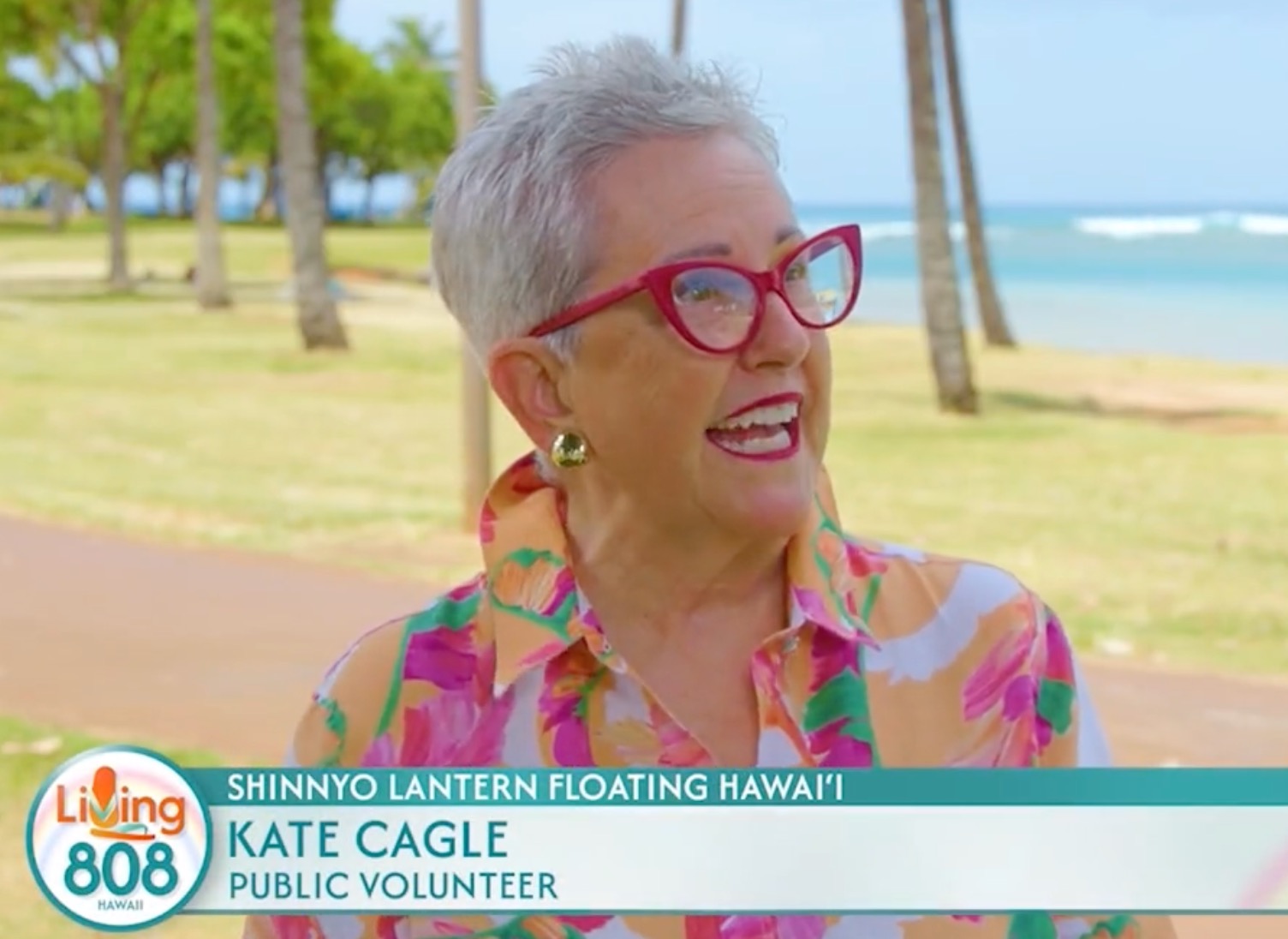 Image of woman at the beach in a Living 808 TV segment, with an onscreen caption that says "Kate Cagle, Public Volunteer."